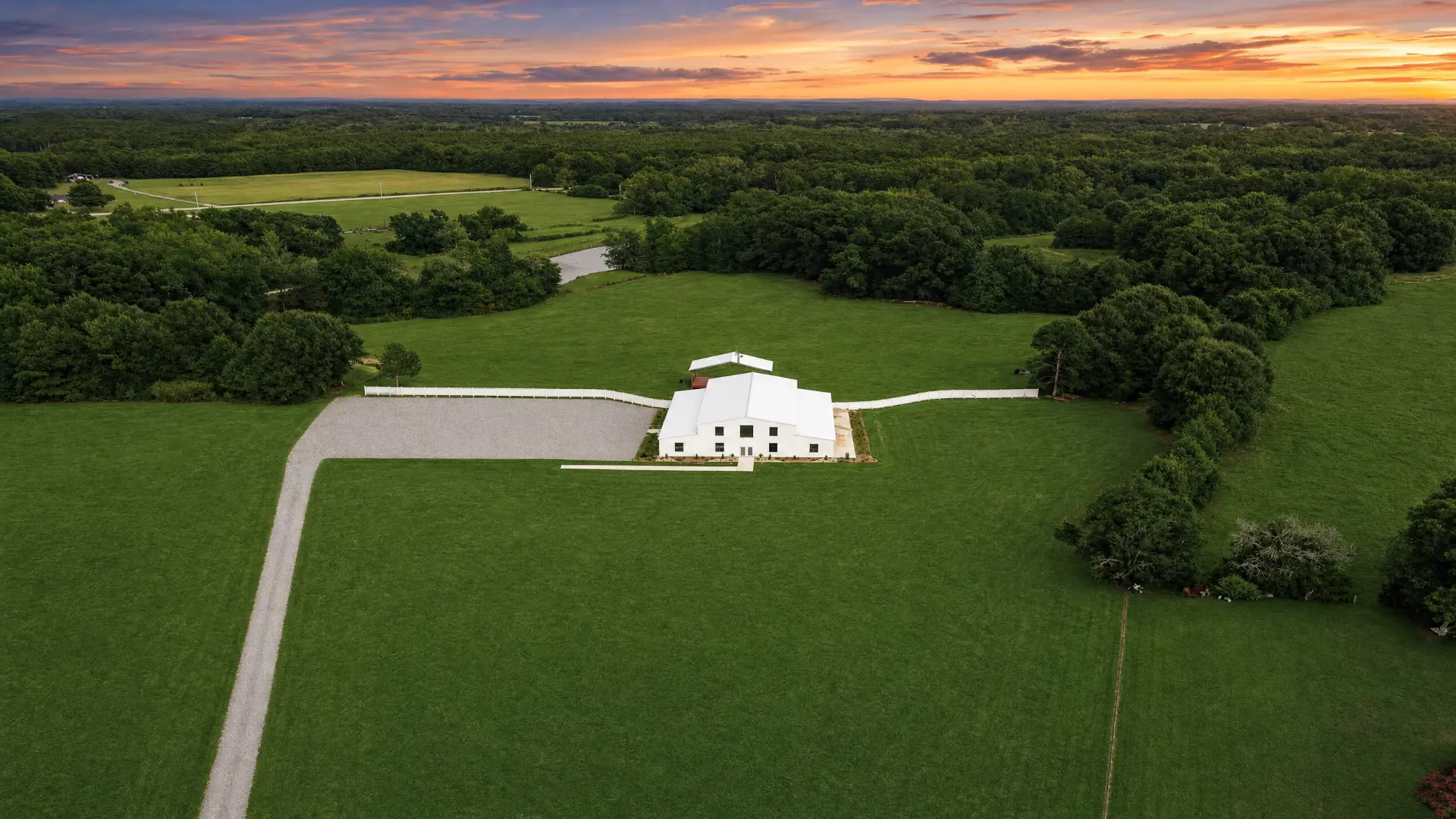 Aerial view of the long gravel drive to the barn