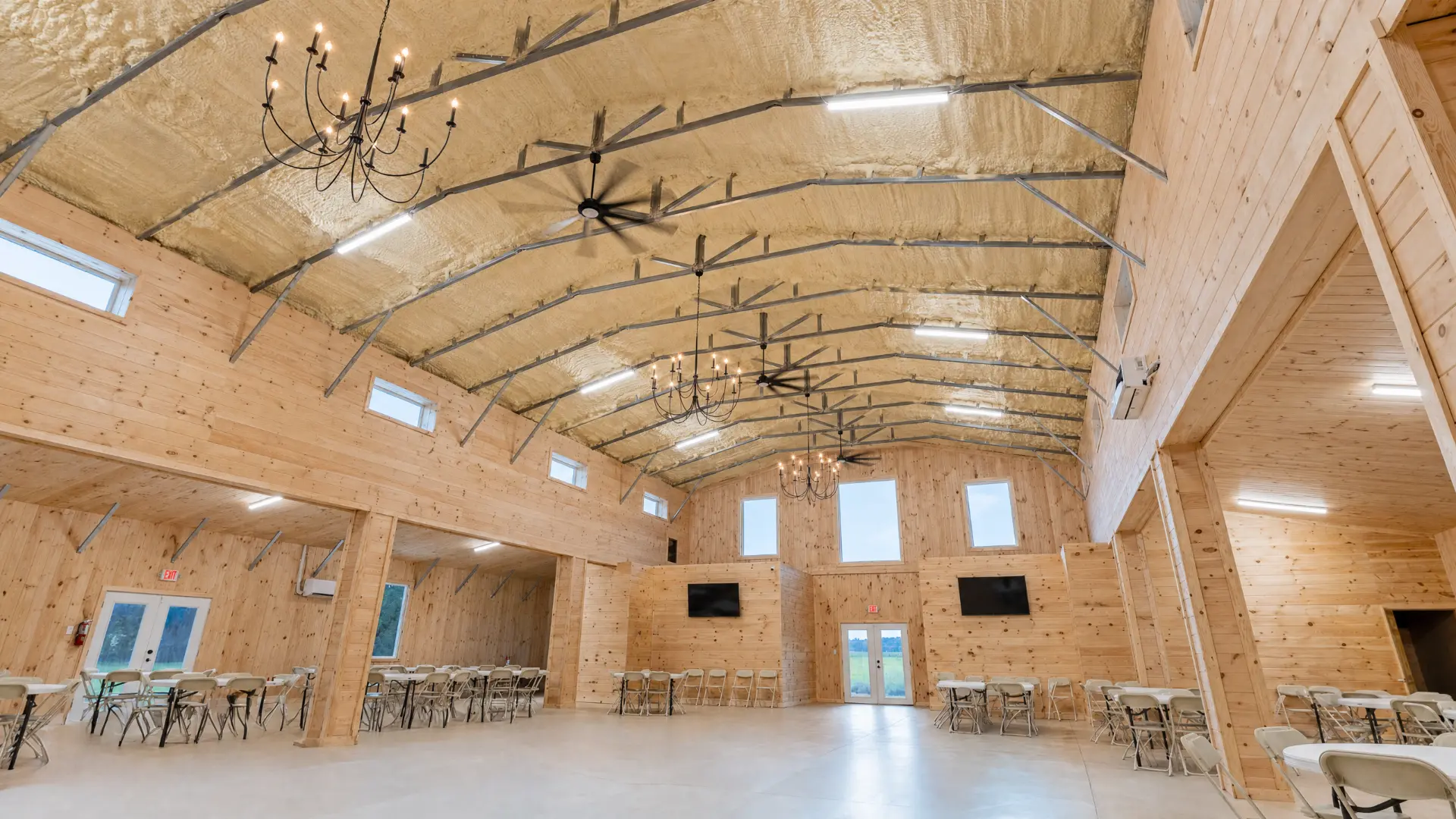 Angled view of the barn event hall with tables set along the walls