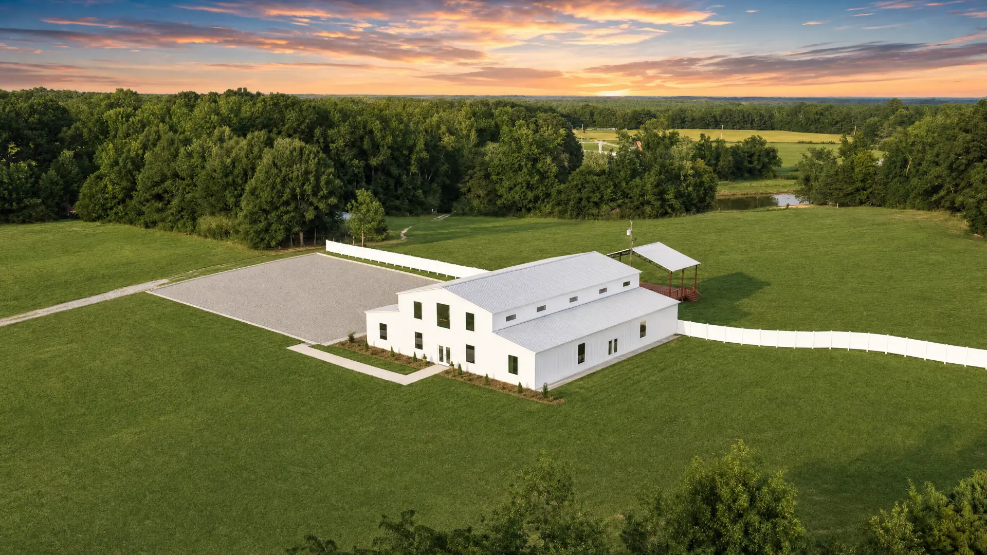 Aerial view of the barn, gravel lot and fenced grounds