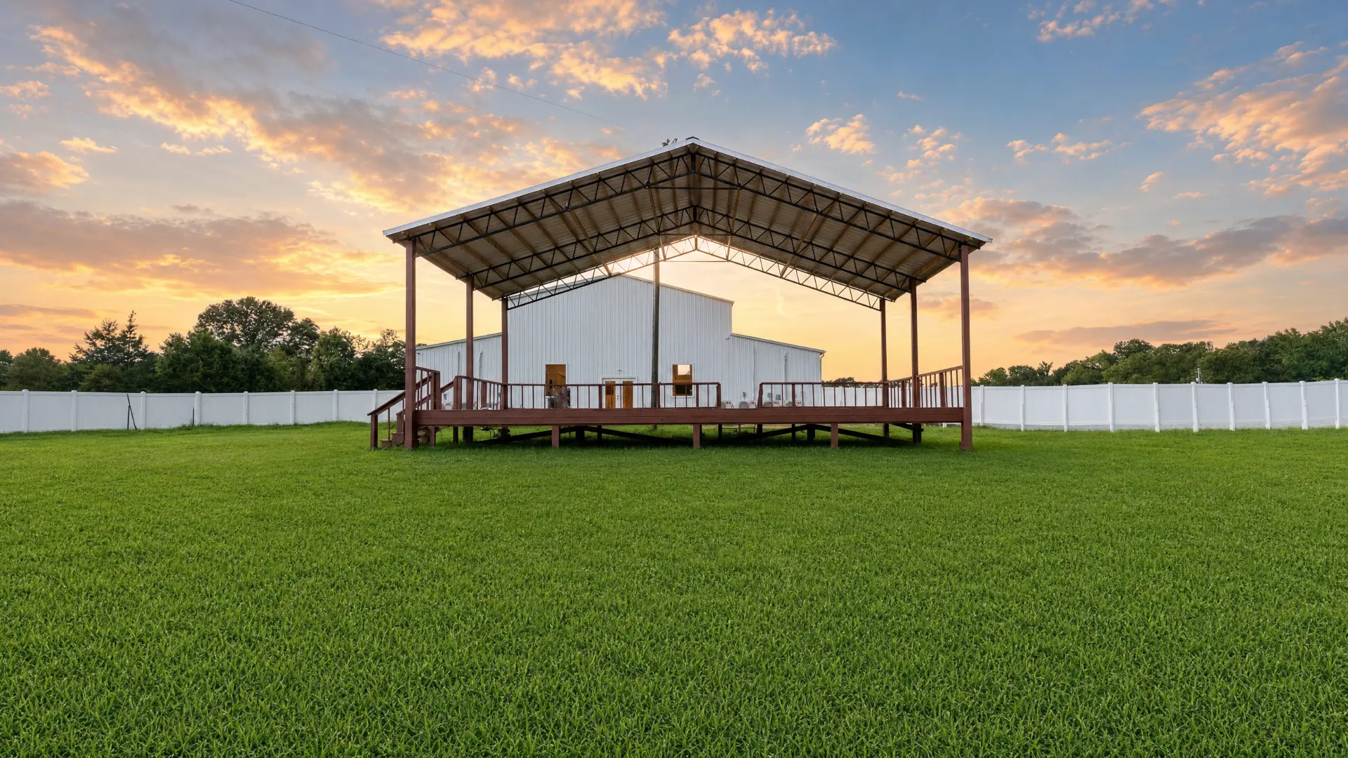 Covered outdoor pavilion on the lawn at sunset