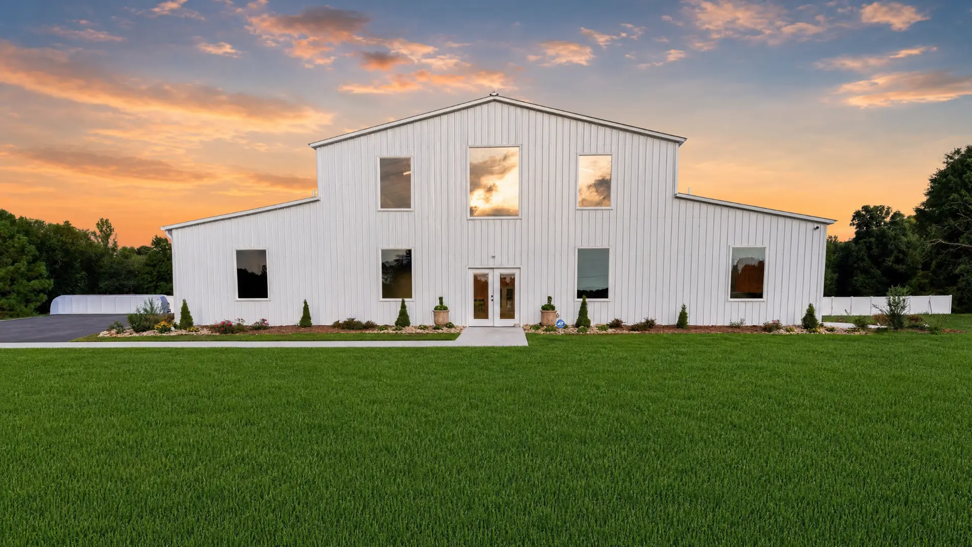 The white barn front elevation at sunset