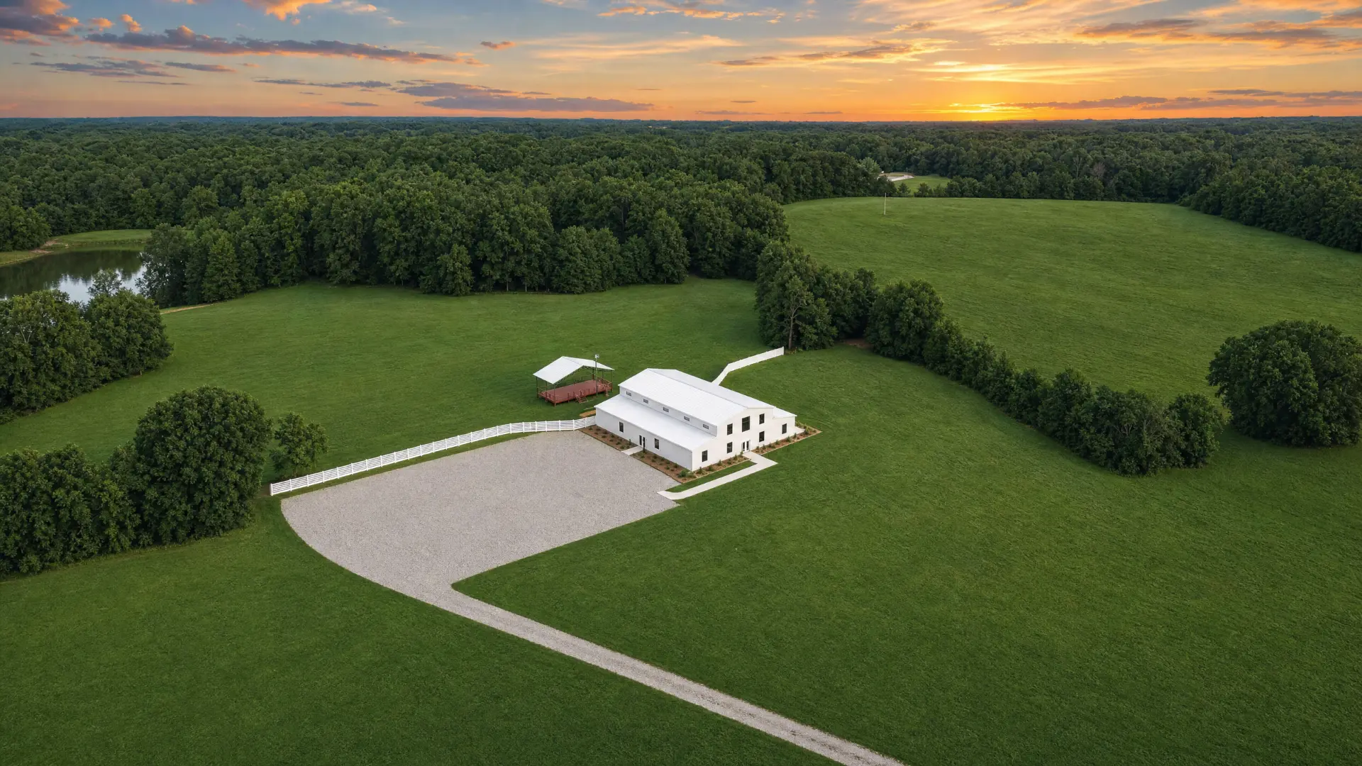 Aerial view of the property with the pond and treeline