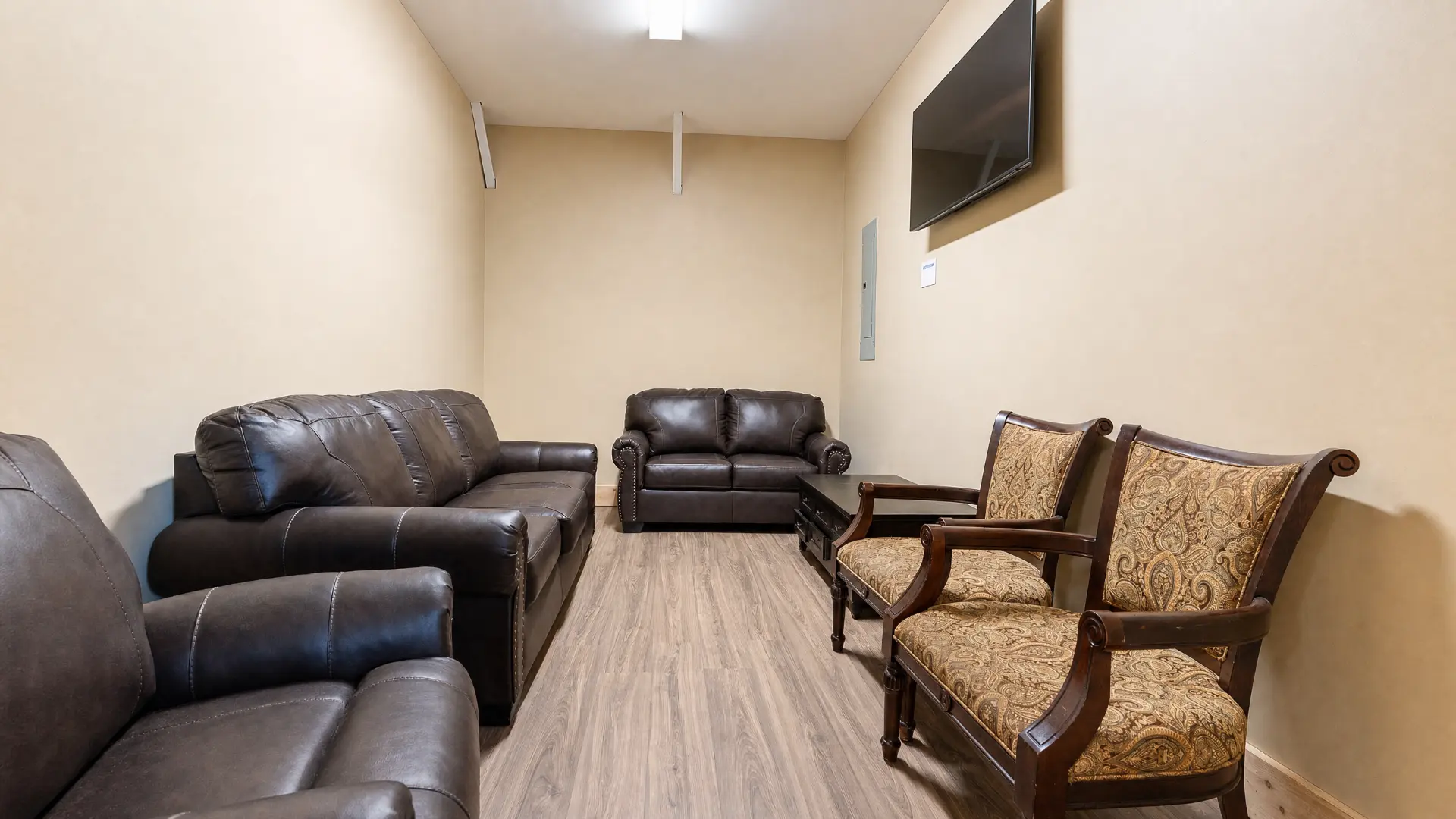 Lounge with leather sofas and wall-mounted television