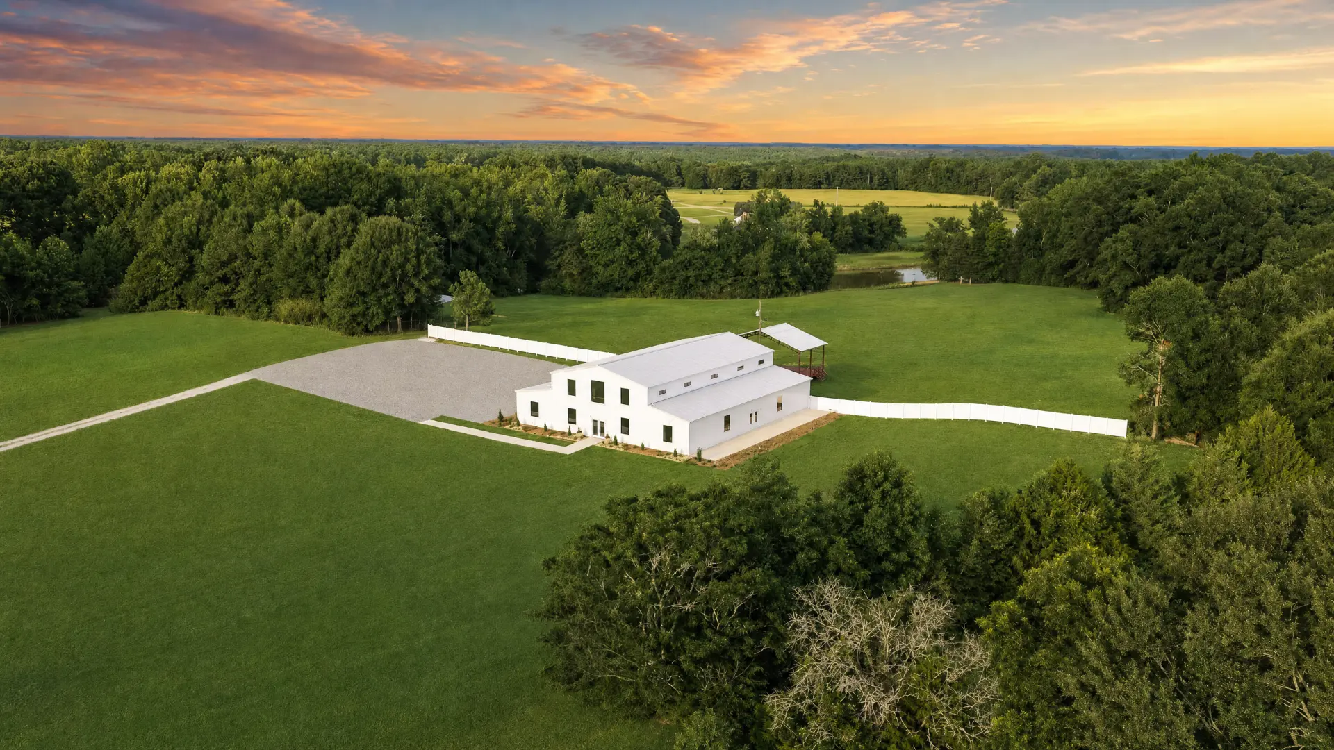 Aerial view of the barn framed by the treeline